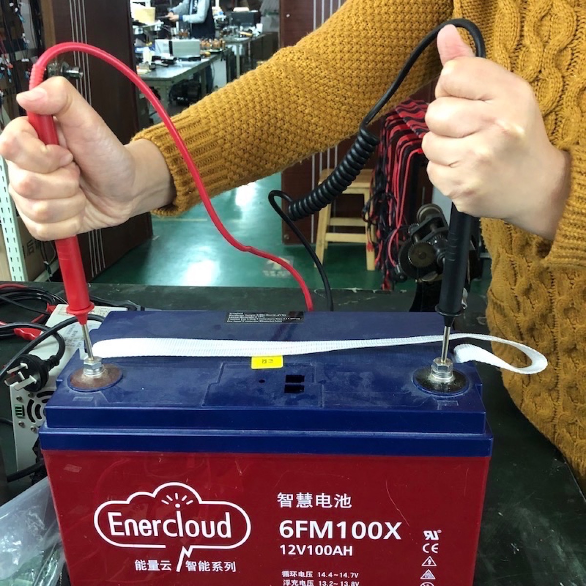 Probe pins pressed onto a battery terminal for PITE3915 testing